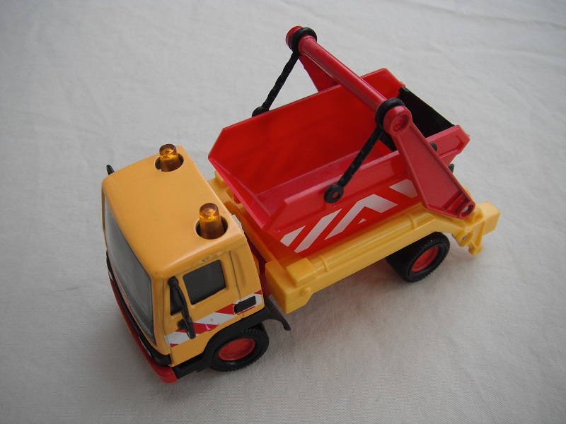 5. Orange-yellow cab/dk. red skip/ light Leyland background/ amber roof light/red &amp; white stripes/red China base.