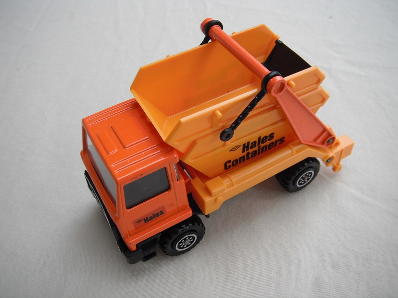 9.  Dark orange cab/type 2 cab roof/dark yellow skip/black base/hales label on cab door/small steering wheel/copper axles.