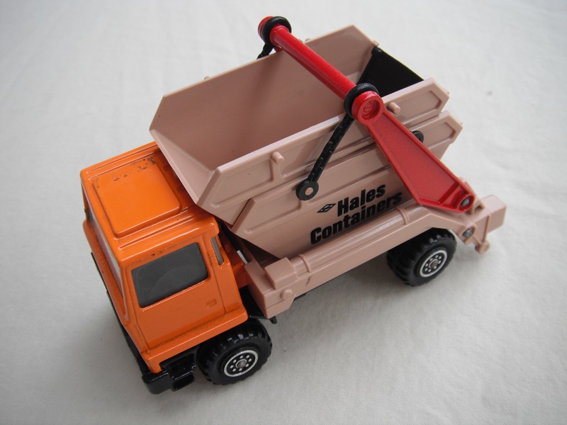 5.  Light orange cab/type 1 cab roof/tan skip/black base/no label on cab door/large steering wheel.