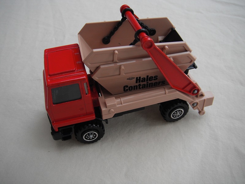 4.  Red cab/type 1 cab roof/tan skip/black base/no label on cab door/large steering wheel.