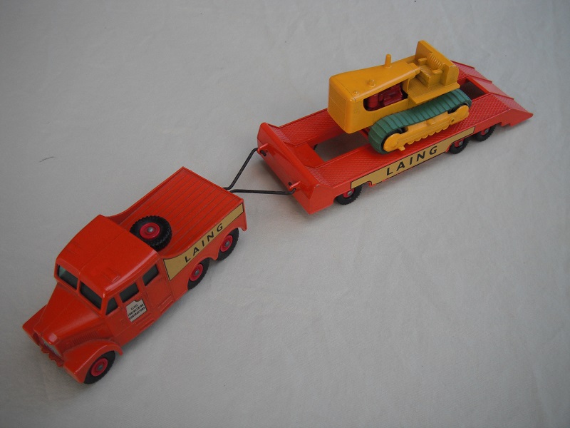 10. Dk.orange truck/red hubs/cut out door decal on tractor/lt.orange painted headlights/Laing yellow decals/yellow tractor with metal rollers.