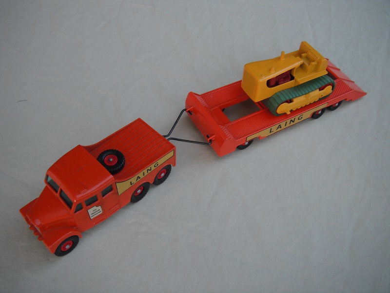 9.  Orange truck/red hubs/cut out door decal on tractor/small text/silver painted headlights/Laing yellow decals/yellow tractor with red rollers.