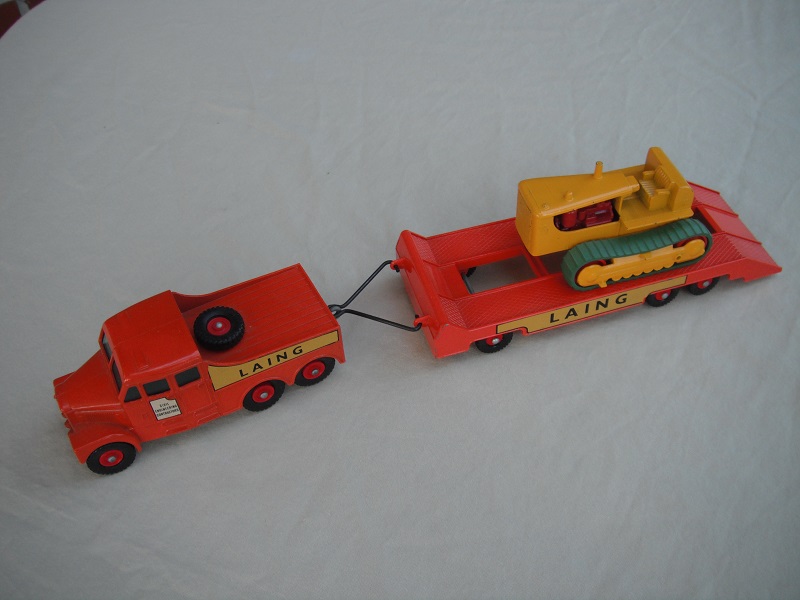 6.  Orange truck/red hubs/cut out door decal on tractor/silver painted headlights/Laing yellow decals/yellow tractor with red rollers.