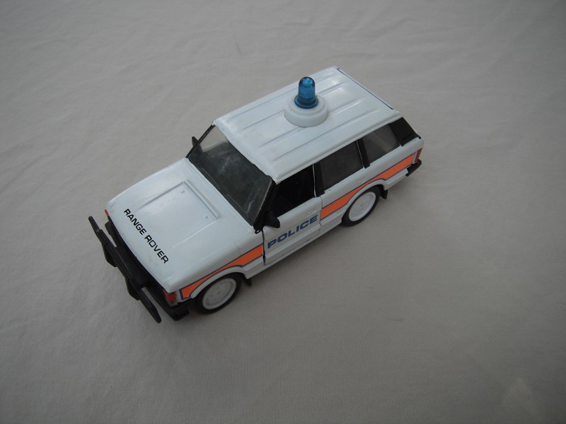 3.  White body/black plastic base/clear windshield/black interior/Police/orange side stripe/China cast.