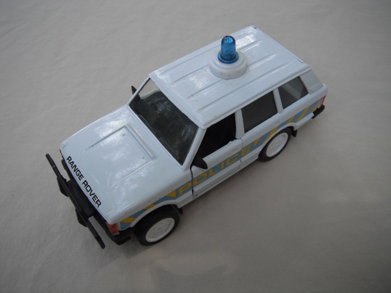 2.  White body/black plastic base/clear windshield/black interior/Police/lt blue &amp; yel stripes/China cast.