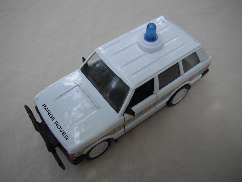 1.  White body/black plastic base/clear windshield/black interior/Police /lt blue &amp; yel stripes/Macau cast.