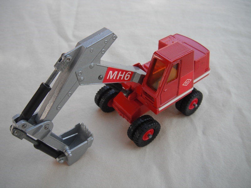 1. Red &amp; silver body/black plastic tires/silver scoop/amber windows/red MH6 &amp; red O&amp;K labels on both sides (R).