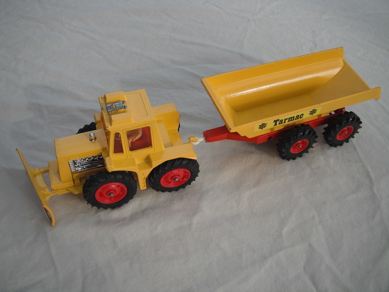 12. Yellow tractor/type 2 plow/thin tires/light amber windows/white driver/dark red interior/yellow &amp; red trailer/large tires/type 2 tow bar/Tarmac label.