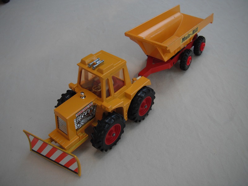 9. Dark yellow tractor/thick tires/light amber windows/translucent driver/dark red interior/dark yellow &amp; dark red trailer/small tires/type 1 tow bar/Muir-Hill label.