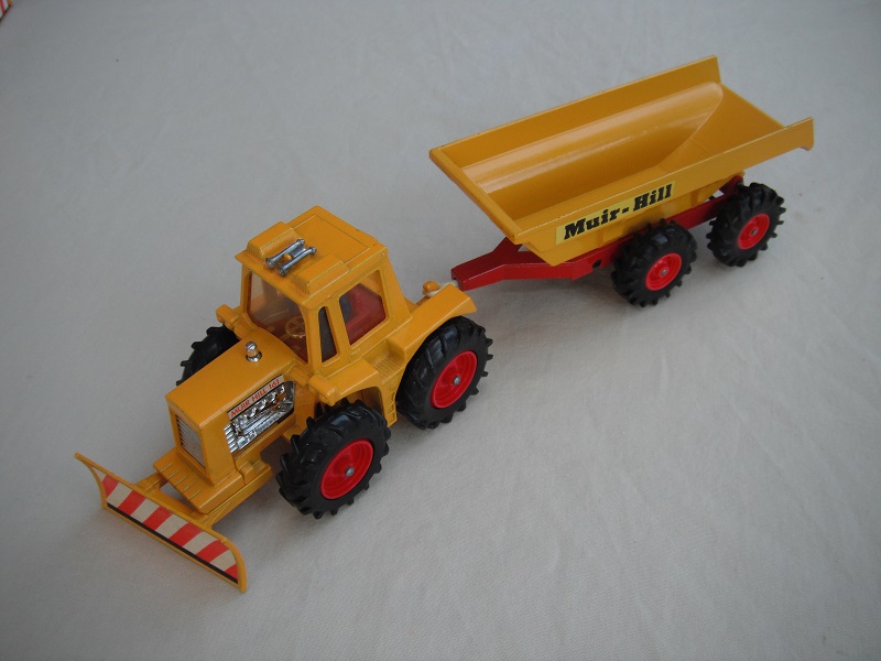 4. Dark yellow tractor/thick tires/clear windows/blue driver/dark red interior/dark yellow &amp; dark red trailer/large tires/type 2 tow bar/Muir-Hill label.