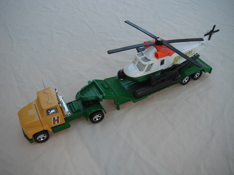 6. Dk.yellow cab/green Lesney base/clear windows/no circle/holes on trailer bed/wht &amp; grn helo w/lt.orange engines/clear windows/lt.green labels.