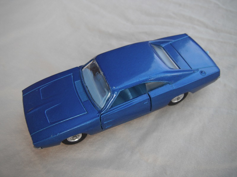 3.  Medium blue body/unpainted base/clear windows/light blue interior/black plastic tires with chrome hubs.