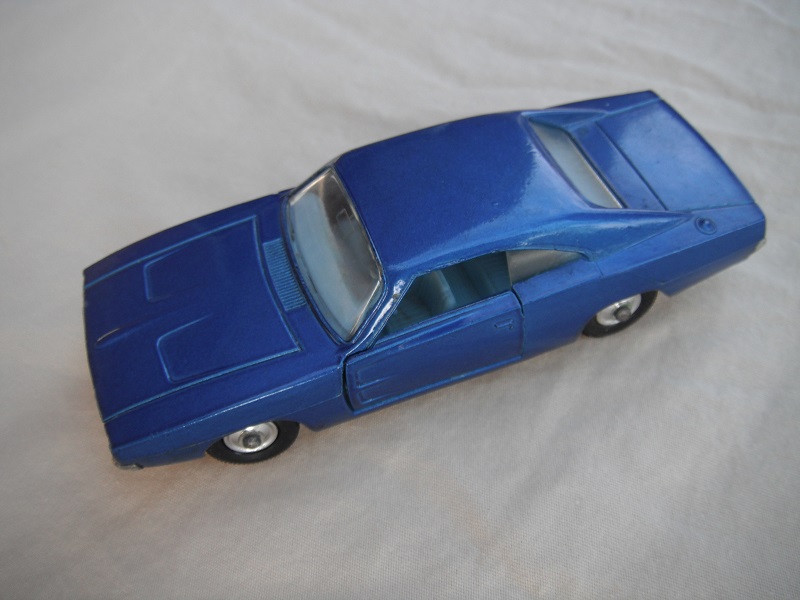 2.  Blue body/unpainted base/clear windows/lighter pale blue interior/black plastic tires with chrome hubs.