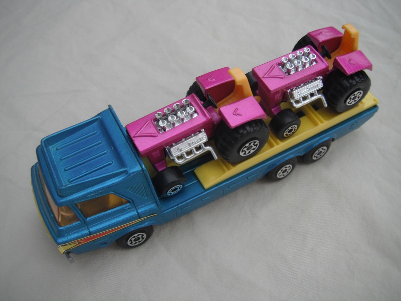 3.  Blue body/silver-gray base/yellow interior/amber windshield/yellow loading ramp/reversed cab labels.