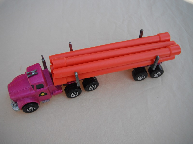 18. Metallic purple cab &amp; trailer/Maltese cross wheels/dark tan axle cover/square hook/orange pipes.