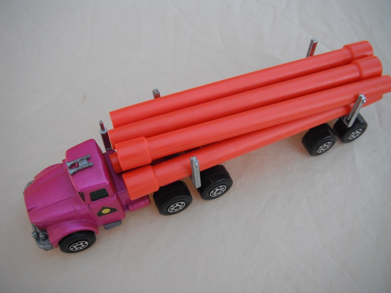 16. Light metallic purple cab &amp; trailer/Maltese cross wheels/light tan axle cover/square hook/orange pipes.