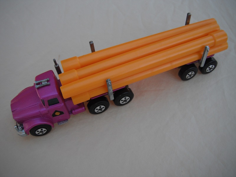 15. Dark metallic purple cab &amp; trailer/large 5 spoke front wheels &amp; rear/dark tan axle cover/square hook/yellow pipes.