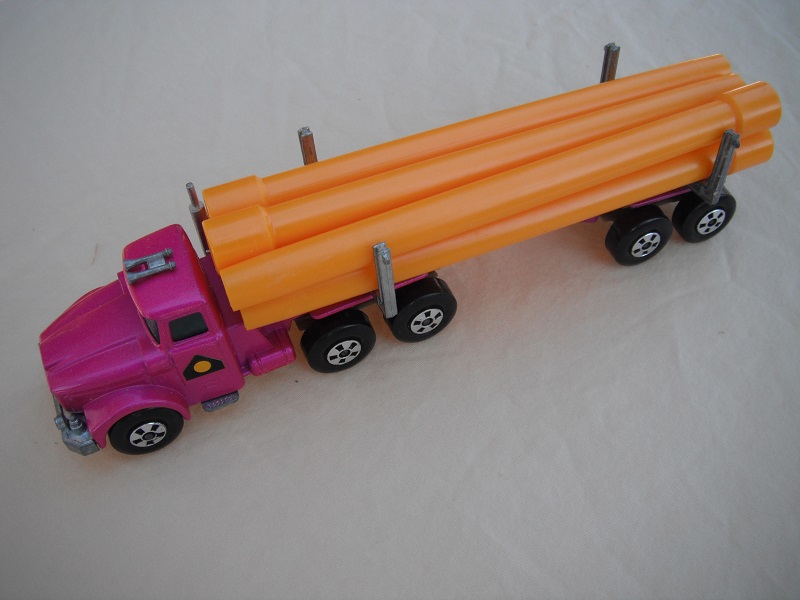 12. Light metallic purple cab &amp; trailer/large 5 spoke front wheels &amp; rear/light tan axle cover/square hook/dark yellow pipes.