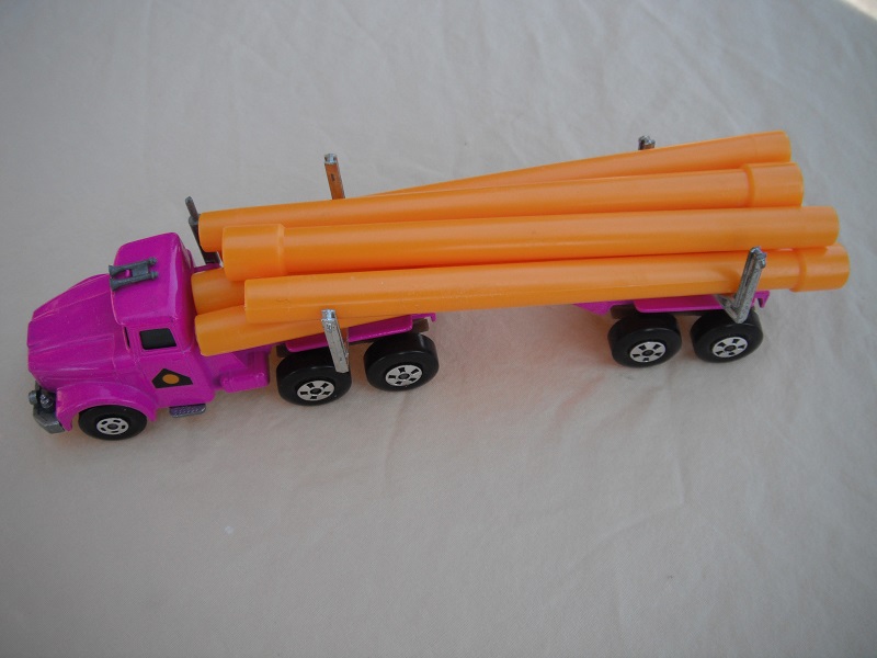 10. Pinkish purple cab &amp; trailer/small 5 spoke front wheels &amp; large rear/light tan axle covers/square hook/dark yellow pipes.