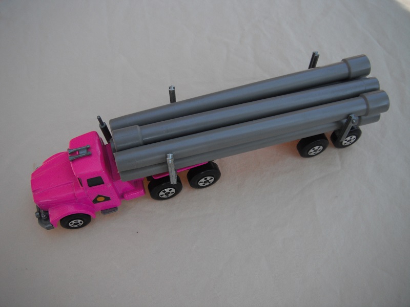 9. Pink cab &amp; trailer/unpainted base/small 5 spoke front wheels &amp; large rear/light tan axle covers/square hook/gray pipes.