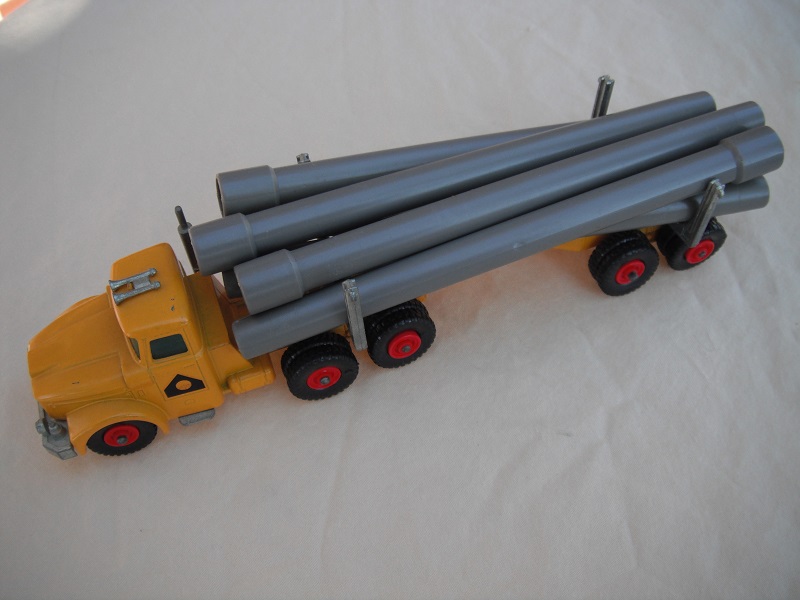 4. Dark yellow cab &amp; trailer/unpainted type 2 base/light green plastic insert/black plastic tires/round hook/gray pipes.