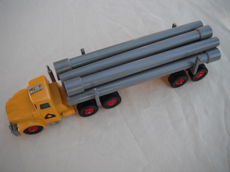 1. Dark yellow cab &amp; trailer/unpainted type 1 base/clear plastic insert/black plastic tires/round hook/gray pipes.