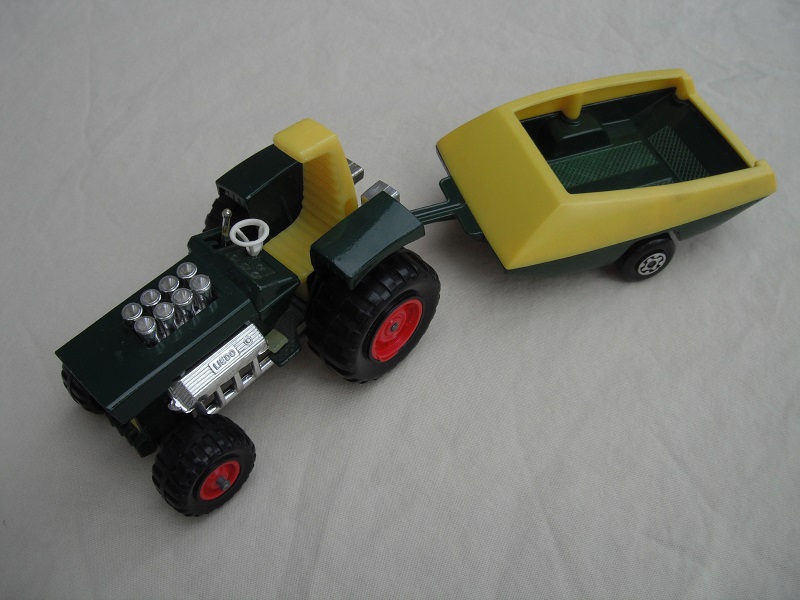 20. Dark green body/yellow seat/dark yellow radiator/light yellow gas pedal/dark green &amp; yellow trailer/no labels/Maltese cross wheels.