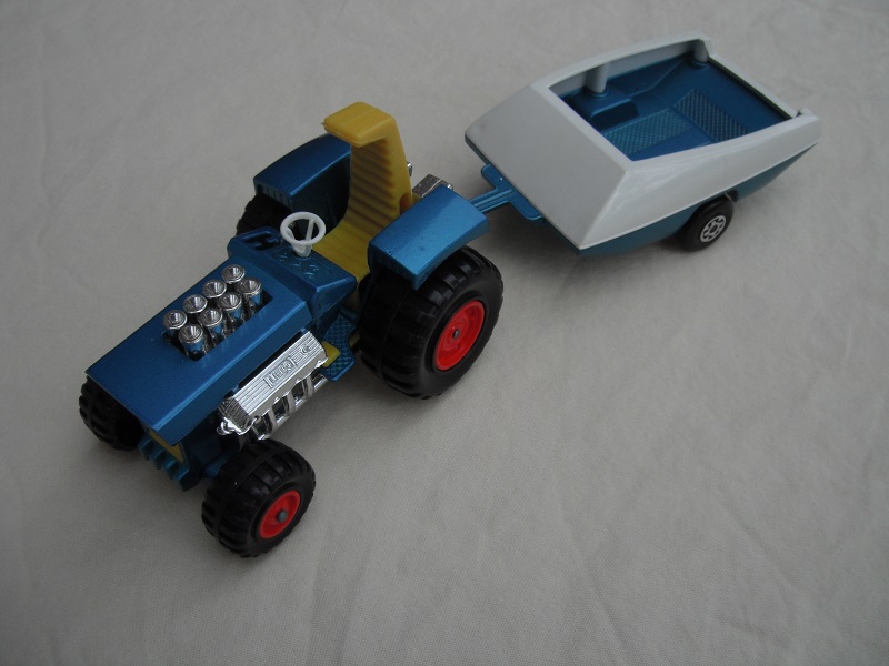 15. Metallic blue body/no label/dark yellow seat/dark yellow radiator &amp; gas pedal/metallic blue &amp; white trailer/no labels/Maltese cross wheels.