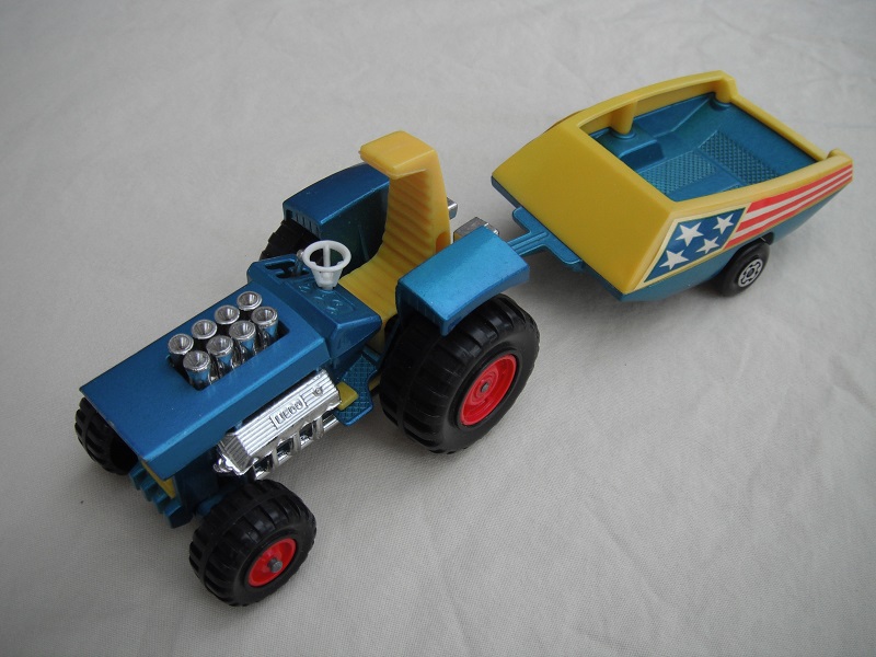 14. Metallic blue body/no label/dark yellow seat/dark yellow radiator &amp; gas pedal/metallic blue &amp; yellow trailer/blue stars &amp; red stripes label/Maltese cross wheels.