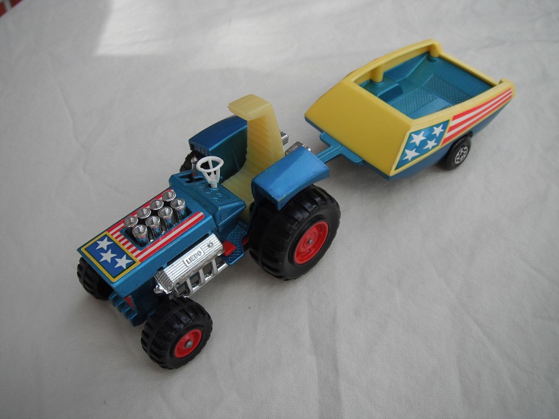 7. Metallic blue body/light yellow seat/red radiator &amp; gas pedal/metallic blue &amp; yellow trailer/blue stars &amp; red stripes label/Maltese cross wheels.