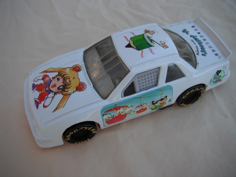 2. PP/White body w/characters/black China base/light gray int/clear windows/Goodyear Eagle in yellow on wheels/&quot;St.Anthony's English Kindergarten&quot;.