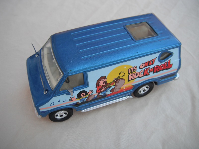 2. Metallic blue body/black base/clear windshield with chrome outline/cream interior with flowers/Its only Rock &amp; Roll.