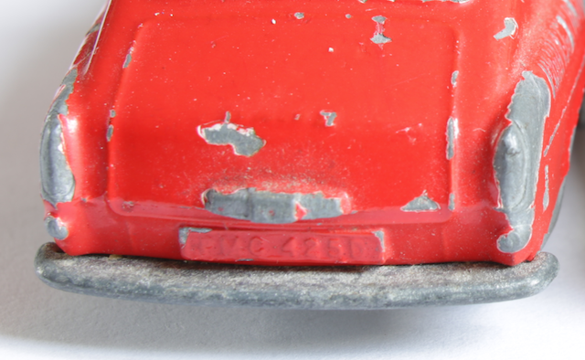 chipped brighter red VW showing white undercoat