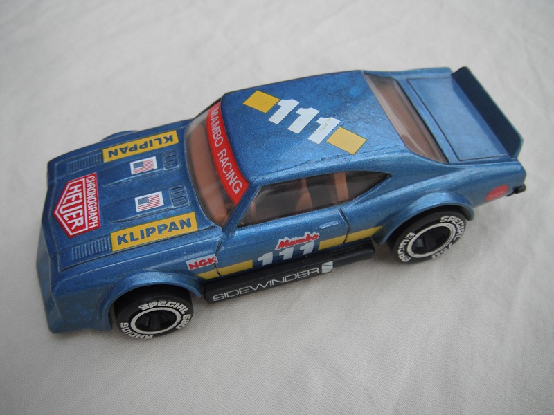 10. Metallic blue body with yellow stripe/black base Macau/brown interior/clear windows/chromed lettering on wheels/Mambo #111.