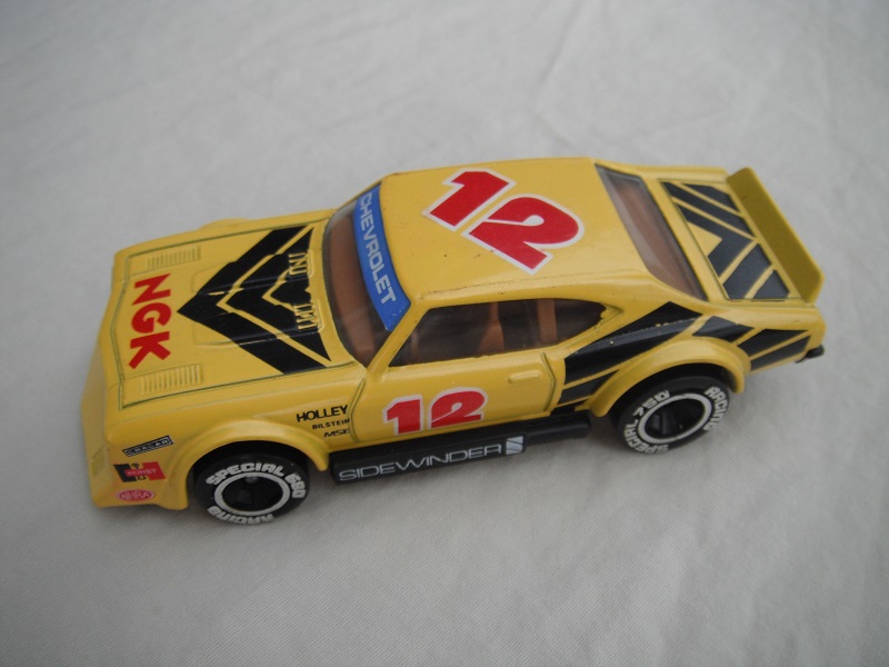 9. Yellow body with black stripes/black base Macau/brown interior/clear windows/chromed lettering on wheels/NGK #12.