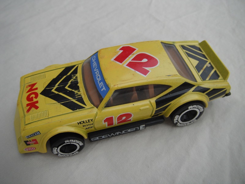 8. Light yellow body with black stripes/black base Macau/brown interior/clear windows/chromed lettering on wheels/NGK #12.