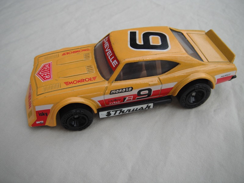 5. Dark yellow body with dark red &amp; white stripes/black base China/brown interior/clear windows/no chromed lettering on wheels/Moroso #9.