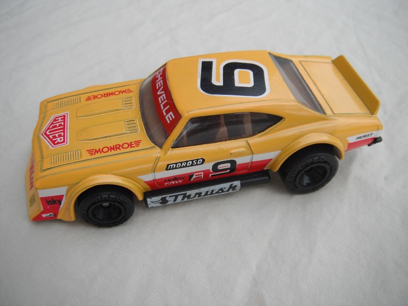 4. Yellow body with red &amp; white stripes/black base China/brown interior/clear windows/no chromed lettering on wheels/Moroso #9.