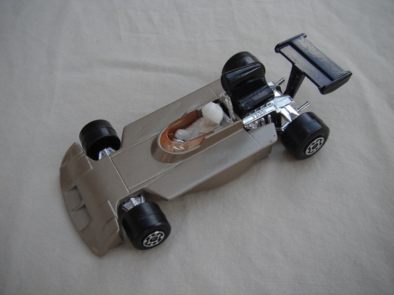 3. Light metallic gold body/black Superking base/black airfoil/amber windshield/white driver w/large white helmet.