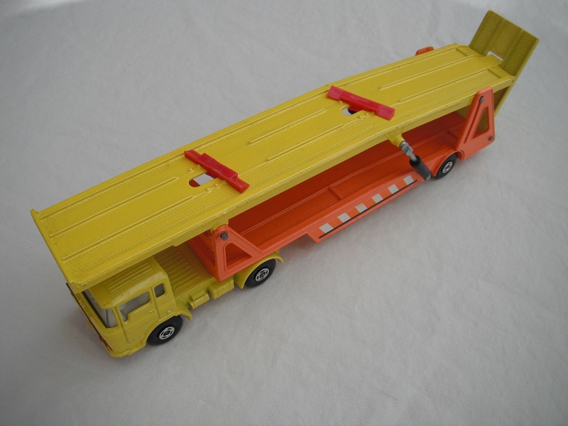 12. Yellow cab/dark red Superkings base &amp; grill/clear windows/4 spoke wheels/yel &amp; org trailer/type a/white axle cover f.fwd/red whl chocks/org &amp; wht stripes.