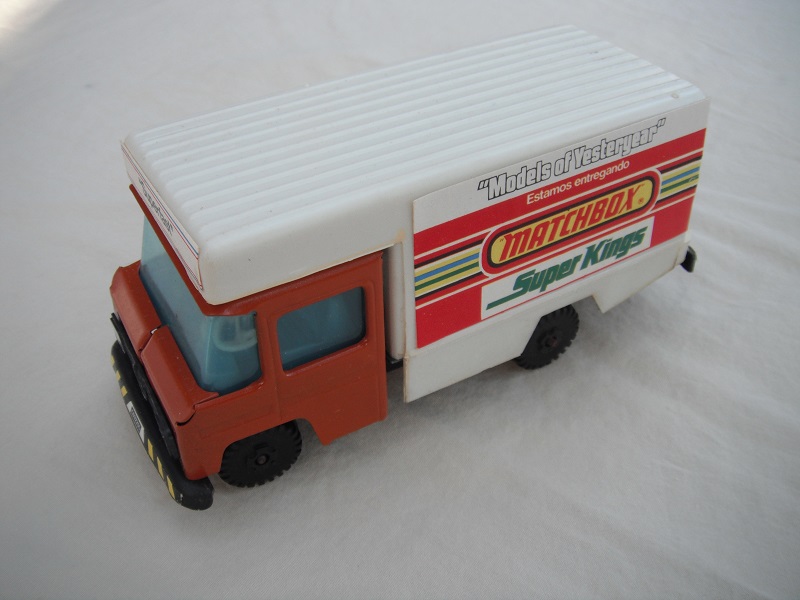 3. Brown cab/white plastic body/metal base/black plastic wheels/light blue interior &amp; windows/white blue steering wheel/labels w/various adverts of Matchbox ranges.