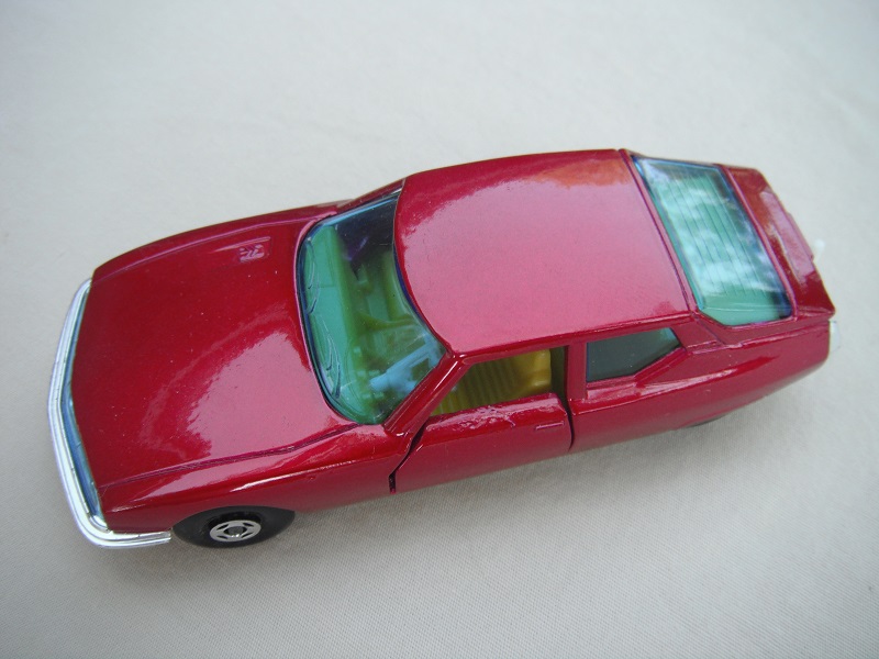 6. Dark magenta body/silver painted base/green windows with lines on rear/yellow interior/tow hook.