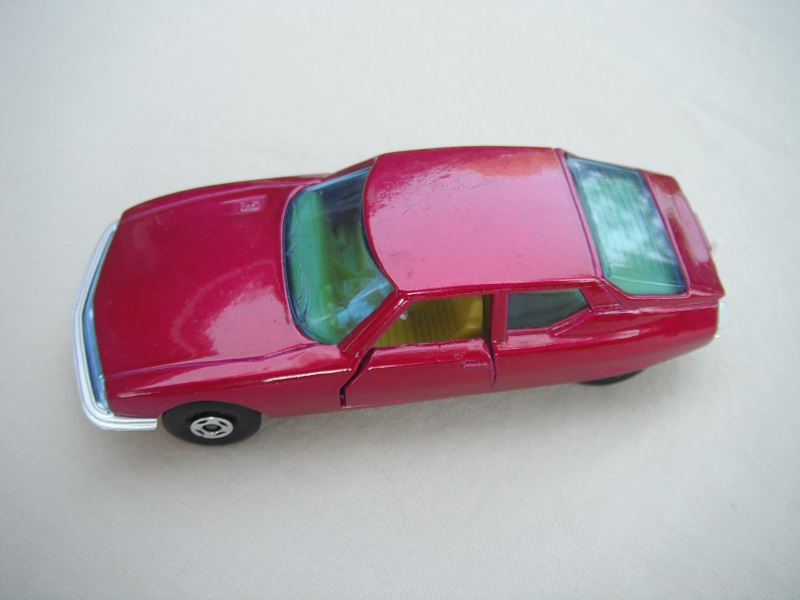 5. Magenta body/silver painted base/green windows with lines on rear/yellow interior/tow hook.