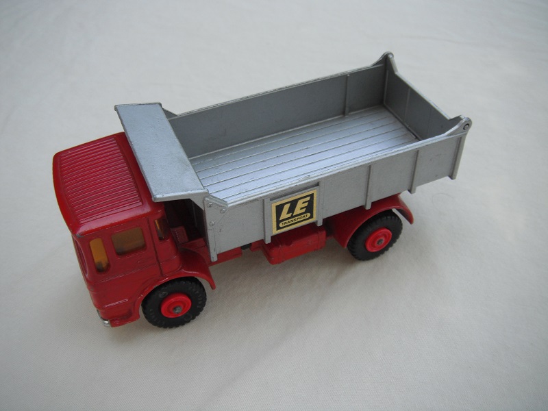 9. Dark red cab/silver tipper/silver base/black plastic tires/amber windows/silver grill &amp; bumper/LE label/out #6 tailgate.