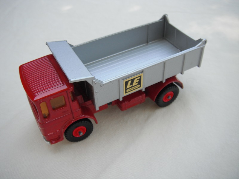 7. Light red cab/silver tipper/silver base/black plastic tires/amber windows/silver grill &amp; bumper/LE label/out #4 tailgate.