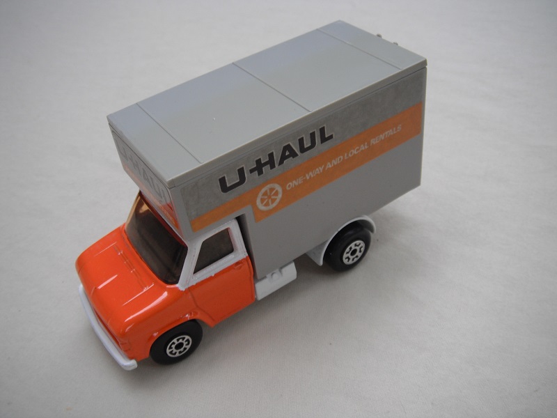 22. Orange &amp; white cab/white base/gry roof/amber windows/5 arch(f)5 crown(r) wheels/blk axle cover/U Haul labels.