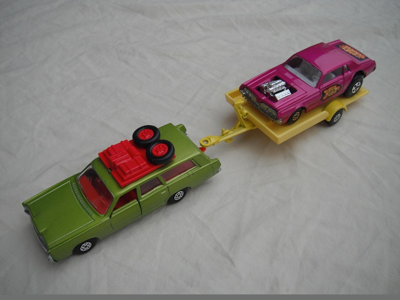 7.  Metallic green Mercury/unpainted K23 England base/dark red interior &amp; roof rack/clear windows/yellow trailer K28-1/type B/ metallic purple Cougar.