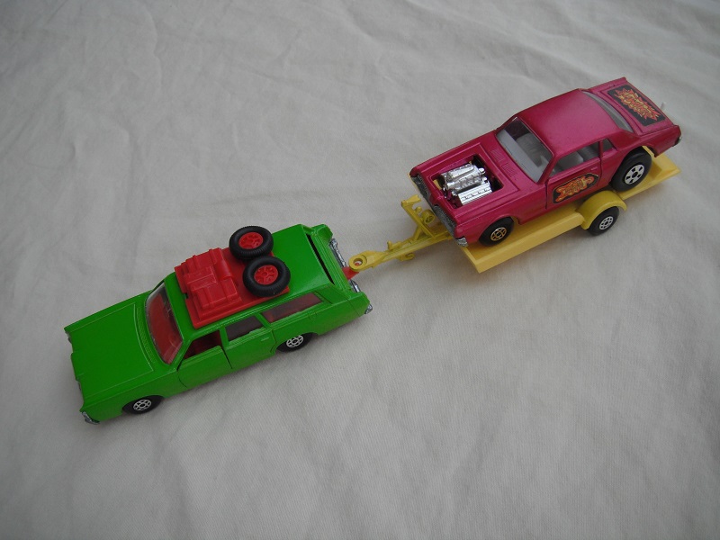 4.  Dark lime green Mercury/unpainted K23 England base/dark red interior &amp; roof rack/clear windows/yellow trailer K28-2/type B/ metallic purple Cougar.