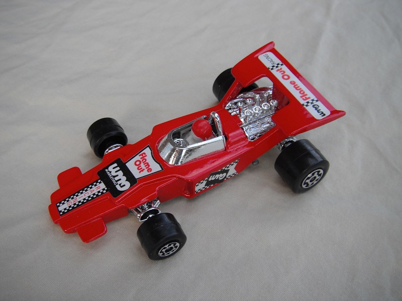 6. Dk.red body/unpainted Speedkings base/type A whls/white driver with red helmet/&quot;Flame out&quot; labels/upside down rear label/irregular side labels.