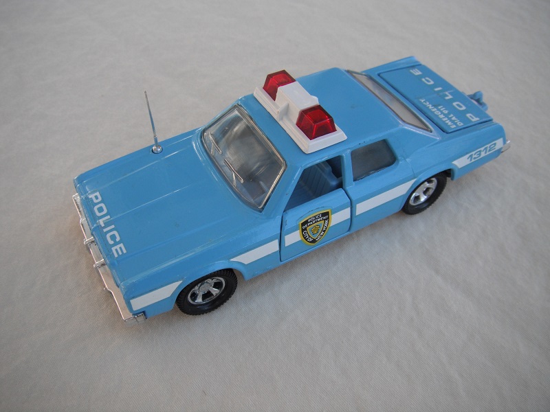 8. Lt. blue body &amp; roof/black England base/pale blue interior/clear windows/no trim/red dome lights/white frame/NYC Police decals.